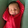 baby, child, closed_eyes, cozy, cushion, cute, face, head, indoor, infant, newborn, peaceful, portrait, red_onesie, relaxed, resting, skin, sleeping, small_hands, soft_fabric