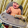 baby, child, high_chair, birthday, crown, number_one, balloon, smile, happy, celebration, party, gold, decorations, toddler, clothing, indoor, person, jewelry, hand, face