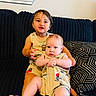 Thiago joined the competition — help win amazing prizes! child, baby, toddler, couch, pillow, patterned_clothing, matching_outfits, indoor, smiling, sitting, black_couch, geometric_pattern, cute, person, family, happy, young_children, home, casual, portrait