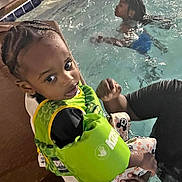 Damere joined the competition — help win amazing prizes! toddler, child, pool, water, floatation_device, swimming, adult_hand, braided_hair, sitting, safety, edge, casual, indoor_pool, clothing, play, fun, young_child, person, water_activity, support