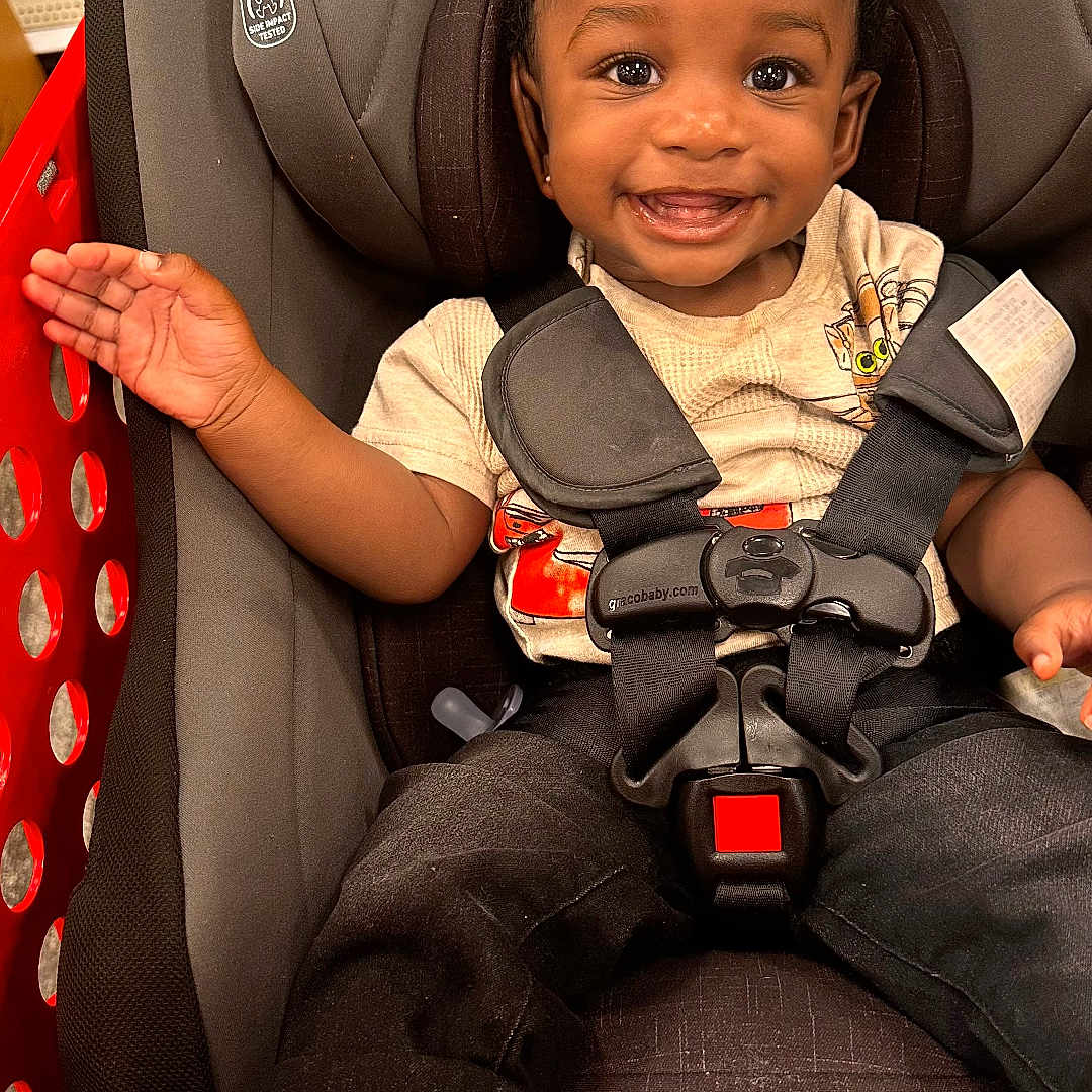 Damere is registered to the contest to win money with this photo: accessories, baby, clothing, coat, cushion, face, footwear, gun, happy, head, homedecor, jacket, pants, person, photography, portrait, shoe, sitting, smile, sneaker