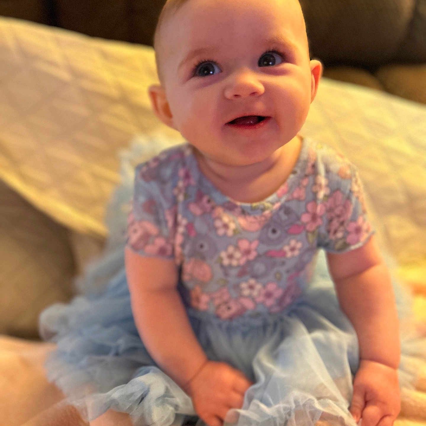 Kinzley is registered to the contest to win money with this photo: baby, babylaughing, clothing, couch, cushion, dress, face, furniture, glove, happy, head, homedecor, laughing, newborn, pants, person, photography, portrait, sitting, smile