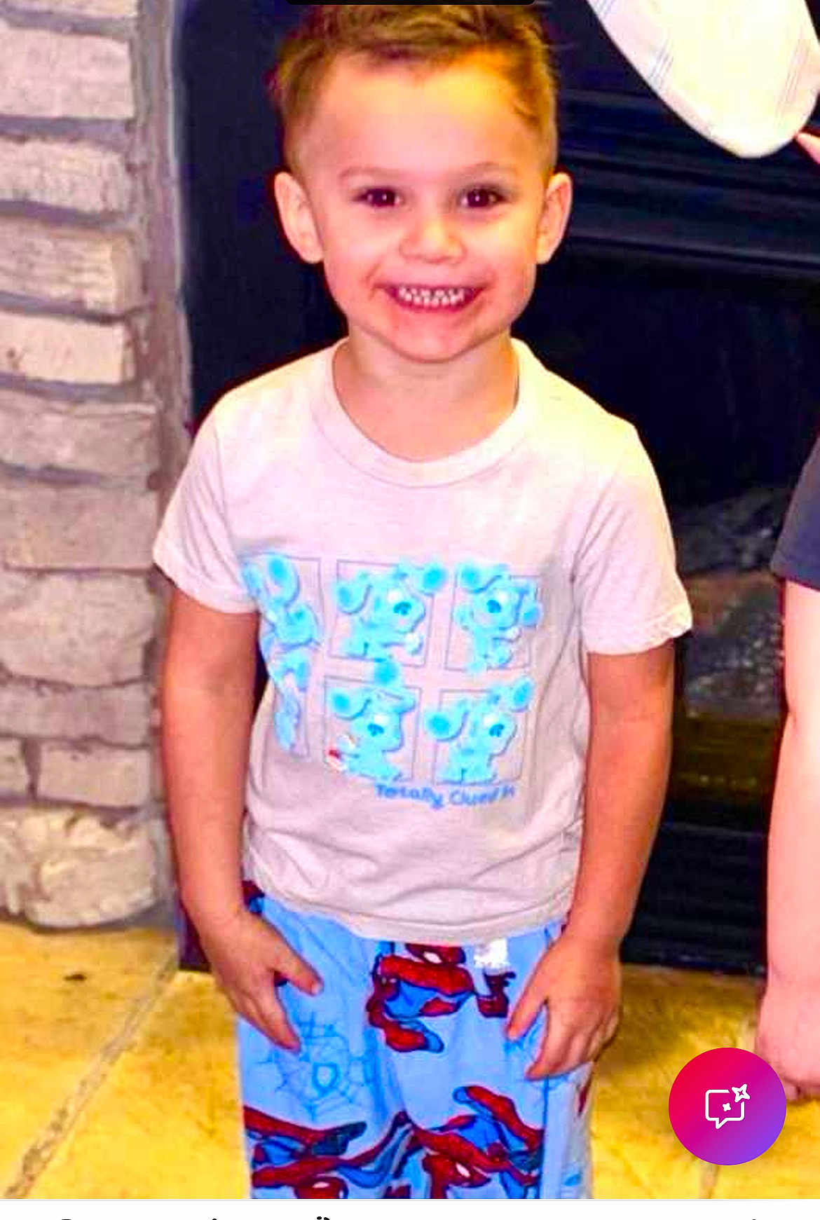 Kholton is registered to the contest to win money with this photo: child, boy, smiling, standing, indoor, tshirt, pajamas, spiderman, cartoon, face, happy, short_hair, stone_wall, fireplace, floor, person, clothing, casual, cute, young