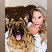Timber joined the competition — help win amazing prizes! woman, dog, german_shepherd, smiling, happy, indoor, couch, hugging, pet, blonde_hair, long_hair, white_shirt, brown_fur, tongue_out, portrait, friendship, cozy, relaxed, companion, animal