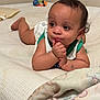 Kai joined the competition — help win amazing prizes! baby, infant, tummy, blanket, toy, curious, hands, face, eyes, skin, hair, clothing, indoor, bedroom, soft, pattern, texture, resting, child, cute