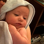 Everette joined the competition — help win amazing prizes! baby, towel, hood, infant, skin, arm, face, person, indoors, soft, blanket, young_child, closeup, resting, cute, newborn, comfort, warm, holding, sleepy
