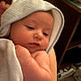 arm, baby, blanket, closeup, comfort, cute, face, holding, hood, indoors, infant, newborn, person, resting, skin, sleepy, soft, towel, warm, young_child