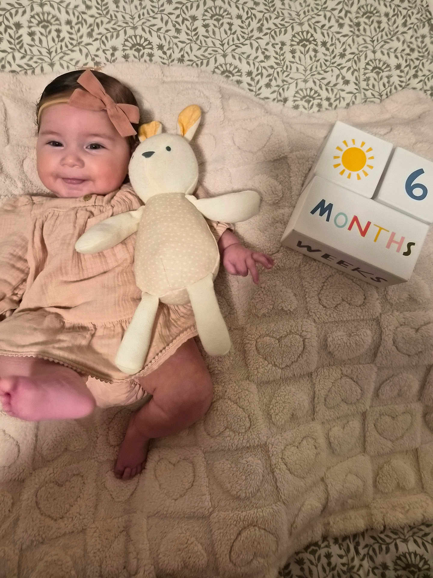 Jade joined the competition — help win amazing prizes! baby, infant, smiling, stuffed_toy, bunny, blanket, heart_pattern, milestone_block, 6_months, clothing, headband, cute, lying_down, soft_texture, indoors, child, happy, celebration, toy, portrait