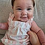 Jade is registered to the contest to win money with this photo: baby, smiling, child, infant, pink_clothing, striped, couch, hand, face, cheeks, eyes, sitting, indoors, cute, portrait, soft_lighting, skin, young_child, happy, person