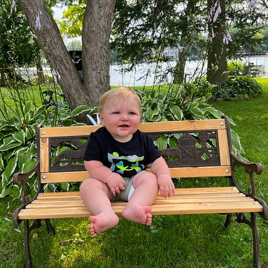 Atticus is registered to the contest to win money with this photo: baby, backyard, bench, face, furniture, grass, head, land, nature, outdoors, park, person, photography, plant, portrait, sitting, summer, tree, vegetation, yard