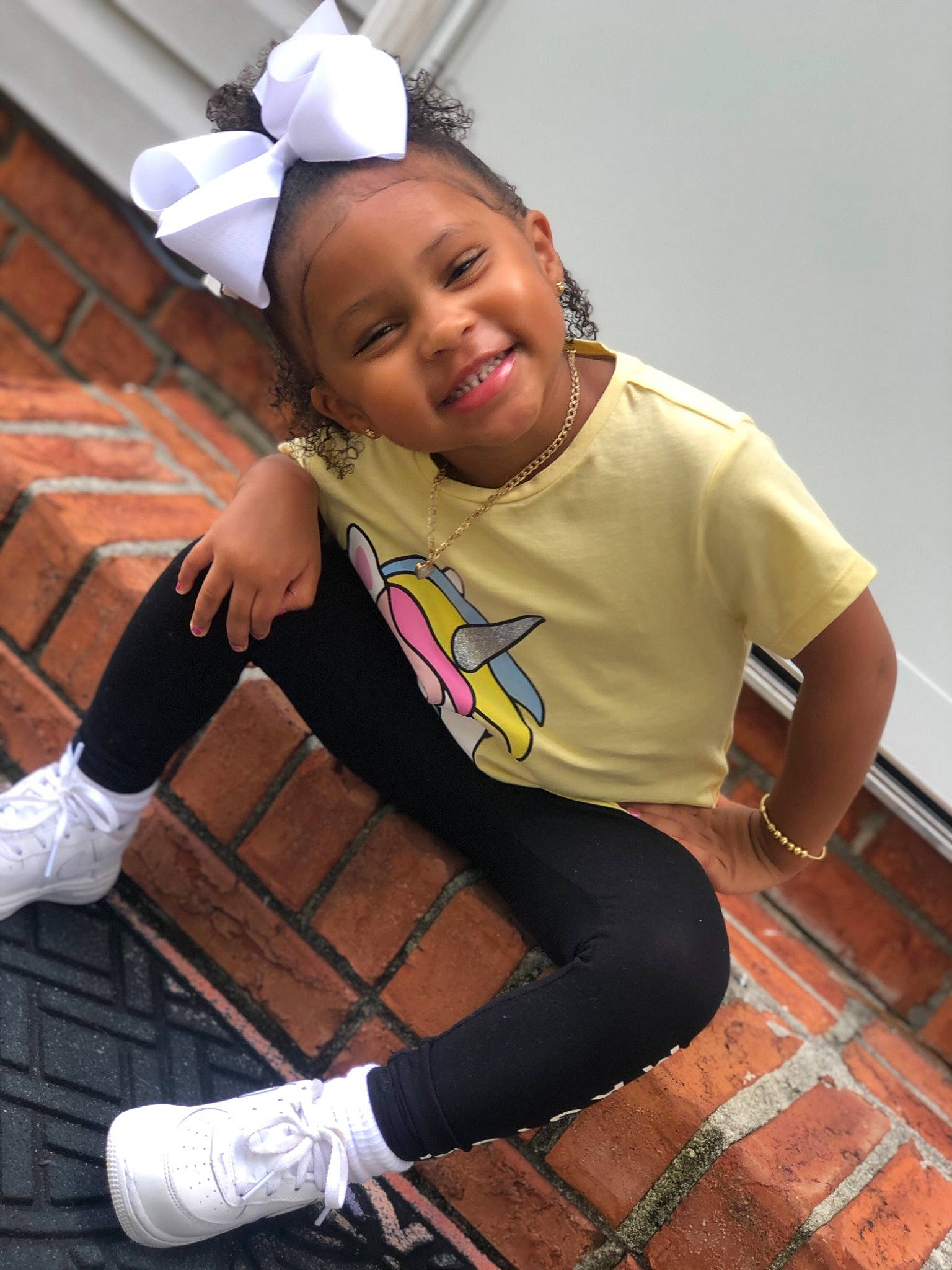 Ayvah Ruth is registered to the contest to win money with this photo: baby_toddler_clothing, brick, brickwork, child_model, costume_accessory, elbow, eye, facial_expression, glove, hair_accessory, happy, headband, headpiece, joy, laugh, long_sleeved_t_shirt, mouth, person, sleeve, sock