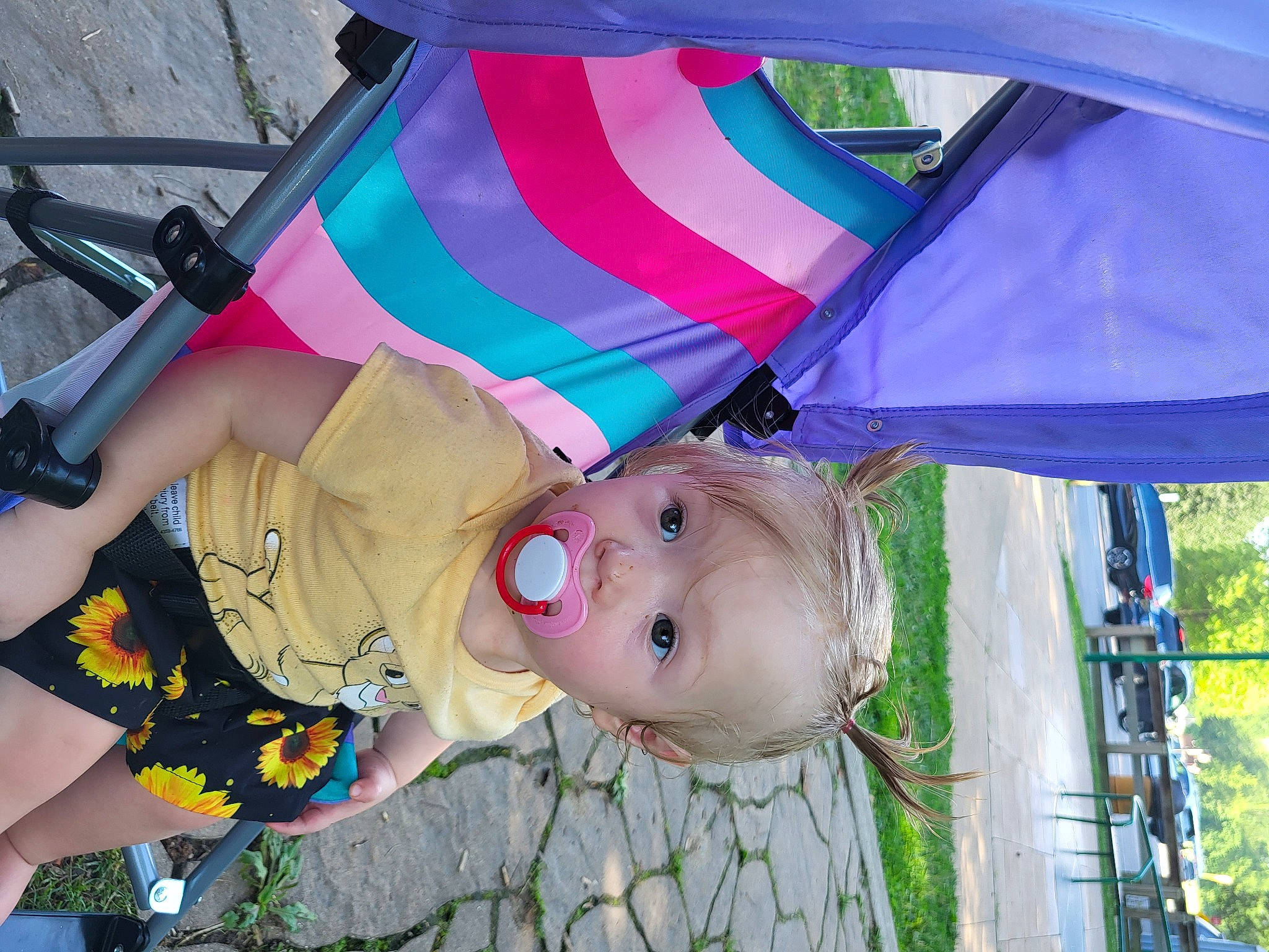 Phoenix is registered to the contest to win money with this photo: baby, baby_products, child, fashion_accessory, fun, grass, happy, hat, leisure, magenta, pattern, people_in_nature, person, plant, recreation, shade, tent, toddler, tree, umbrella