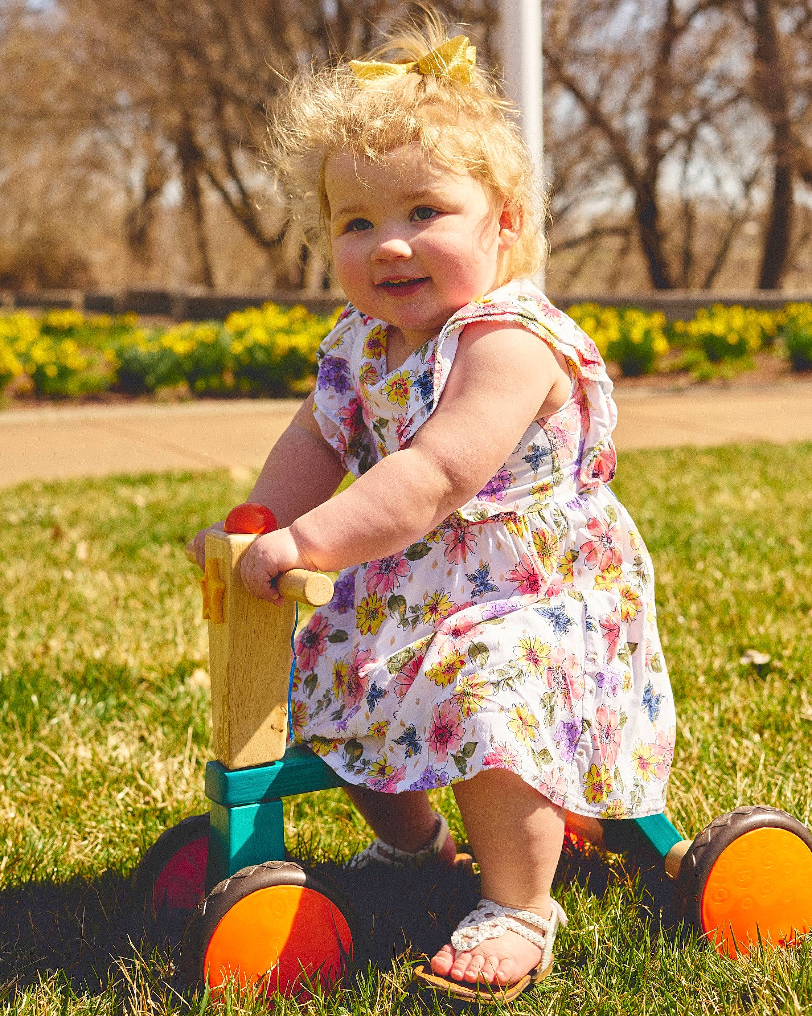 Lilah is registered to the contest to win money with this photo: baby, baby_toddler_clothing, ball, blond, child, dress, fun, grass, happy, joy, lawn, leisure, people_in_nature, person, plant, playing_with_kids, recreation, smile, sunlight, toddler