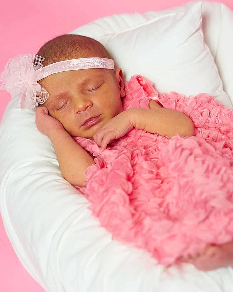 Presley is registered to the contest to win money with this photo: arm, baby, baby_sleeping, baby_toddler_clothing, bed, bedding, comfort, couch, dress, finger, happy, headwear, linens, lip, magenta, neck, pattern, person, pink, skin