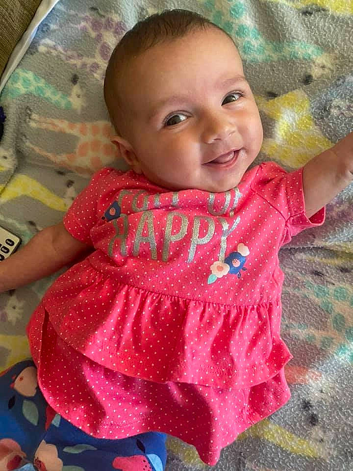 Presley is registered to the contest to win money with this photo: baby, baby_toddler_clothing, cheek, child, chin, dress, finger, happy, iris, joy, lip, mouth, neck, nose, person, pink, product, skin, sleeve, smile