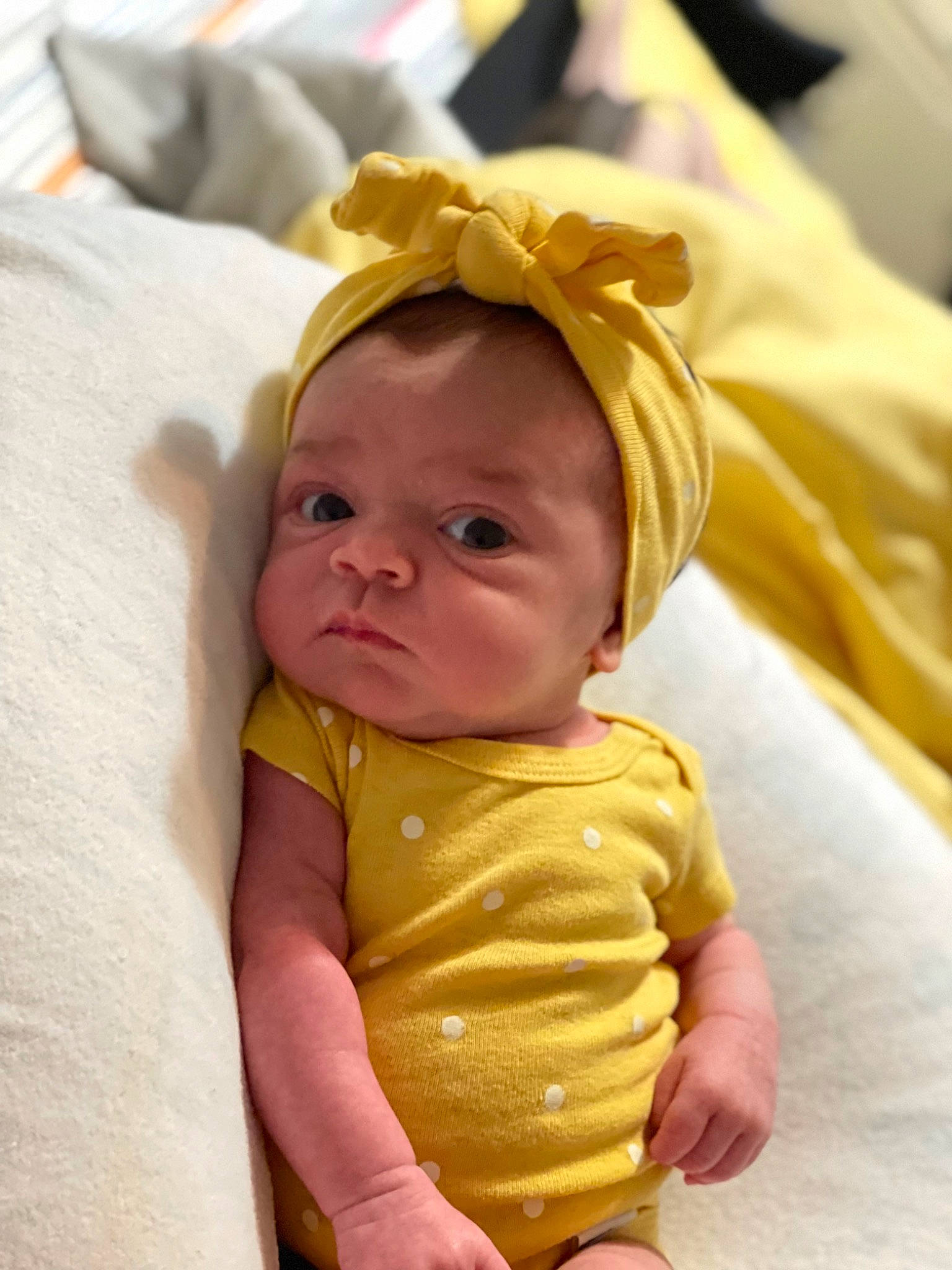 Kayce is registered to the contest to win money with this photo: baby, baby_products, baby_toddler_clothing, cheek, child, comfort, eye, face, fun, happy, head, headgear, iris, linens, lip, person, room, sitting, skin, sleeve