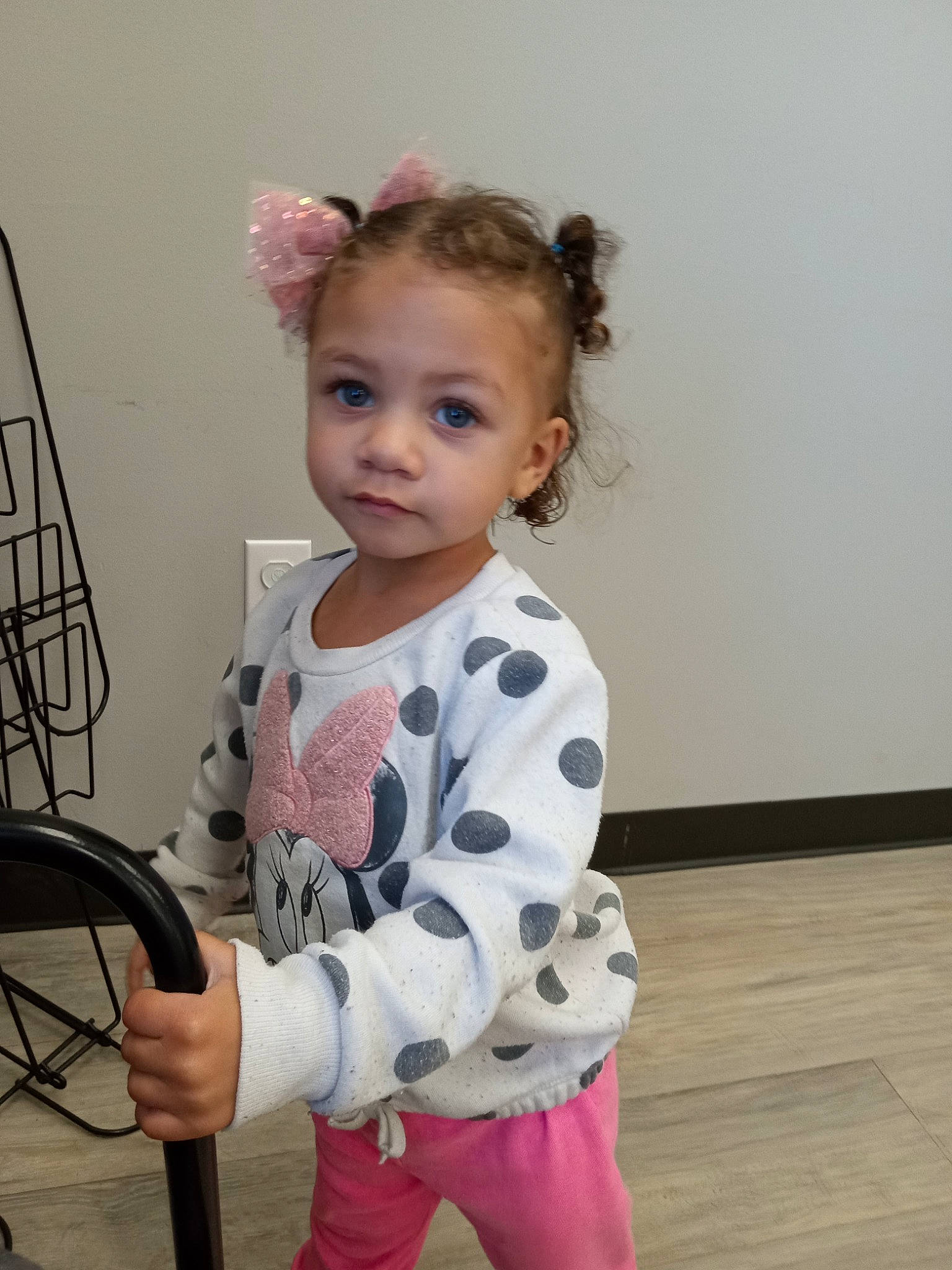 Corina is registered to the contest to win money with this photo: audio_equipment, baby_toddler_clothing, child, eyelash, flooring, fun, hardwood, human_body, pattern, person, play, room, shoulder, sitting, sleeve, t_shirt, toddler, wood, wood_flooring