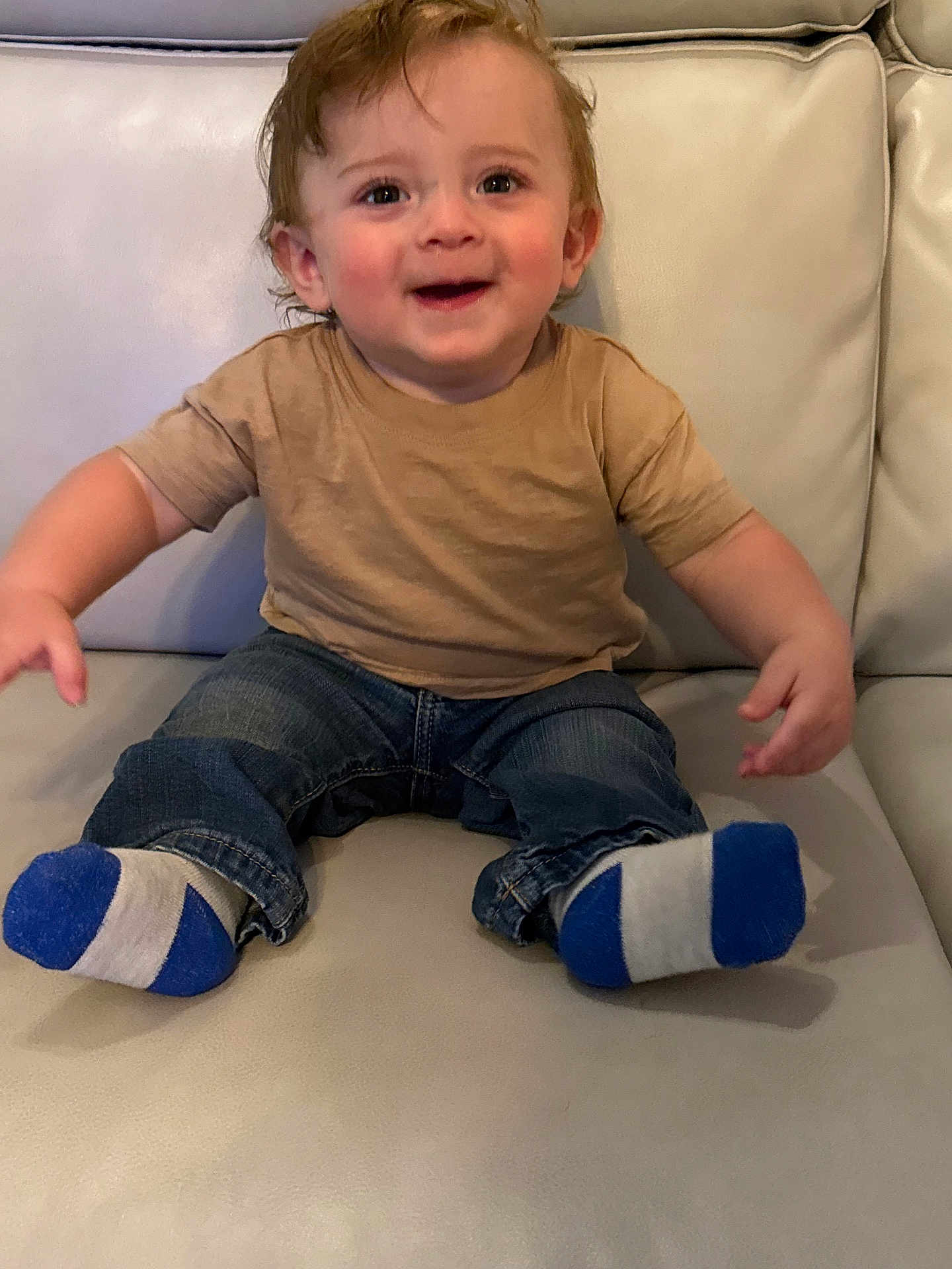 Codye is registered to the contest to win money with this photo: toddler, child, smiling, socks, jeans, tshirt, couch, leather, indoor, hair, happy, sitting, person, clothing, young_child, cute, face, expression, furniture, casual