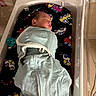 Davier is registered to the contest to win money with this photo: newborn, baby, sleeping, infant, hospital, bassinet, swaddle, blanket, pacifier, portrait, face, closed_eyes, peaceful, mint_green, patterned_liner, vehicle_pattern, medical_setting, resting, bedding, nursery