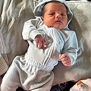 Davier joined the competition — help win amazing prizes! baby, newborn, child, portrait, lying_down, white_clothing, hood, onesie, blanket, pillow, bed, indoor, sunlight, face, eyes_open, serious_expression, hands, infant, soft_fabric, cozy