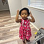 Koila is registered to the contest to win money with this photo: toddler, child, pink_dress, hat, barefoot, indoor, wooden_floor, backpack, window, blinds, curious, standing, young_child, casual, home_interior, playful, portrait, person, flooring, light