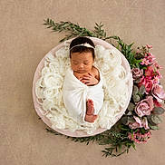 Cateleya participe au concours pour gagner de l'argent avec cette photo : newborn, baby, sleeping, wrapped, blanket, bowl, flowers, floral_arrangement, greenery, soft, white, pink, purple, peaceful, infant, headband, portrait, studio, circular, resting