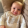 baby, infant, smile, tongue_out, onesie, cushion, soft_texture, face, cheeks, happy, cute, child, portrait, indoor, closeup, clothing, cozy, expression, person, newborn