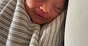 Annaleise is registered to the contest to win money with this photo: baby, newborn, sleeping, smiling, blanket, striped, cozy, wrapped, infant, face, closeup, soft, peaceful, cute, child, portrait, indoors, head, resting, warm