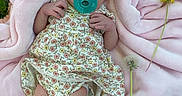 Annaleise is registered to the contest to win money with this photo: baby, newborn, infant, pacifier, pink_blanket, flower, dandelion, grass, headband, sleeping, outdoor, cute, peaceful, floral_dress, nature, child, soft_texture, resting, skin, small