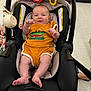 baby, infant, car_seat, orange_clothing, toy, smiling, indoor, store, floor, feet, legs, person, child, cute, seat, play, happy, baby_toy, head, face