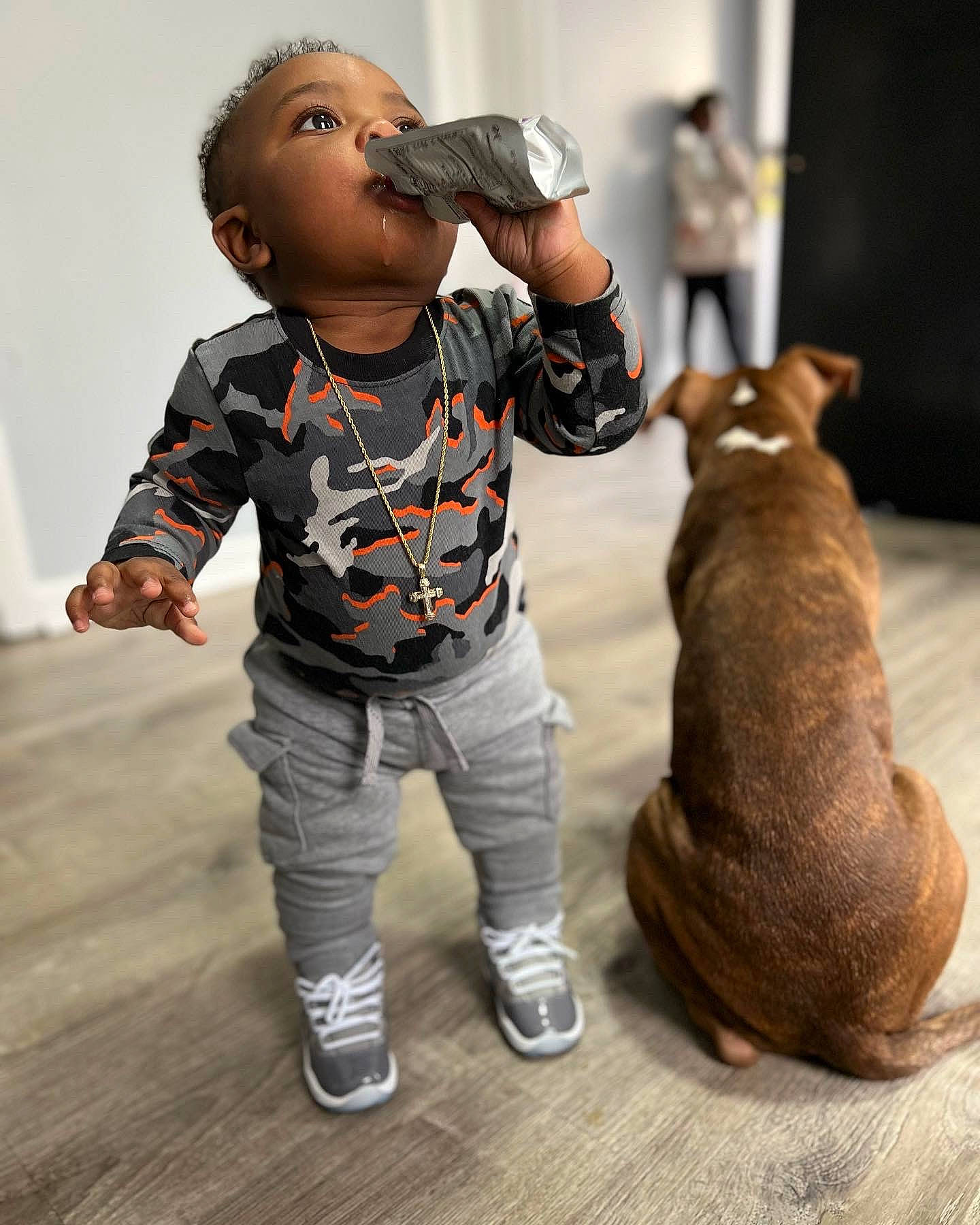 Makhi is registered to the contest to win money with this photo: baby, brown_bear, child, companion_dog, dog_breed, figurine, flooring, fun, fur, gesture, happy, joint, person, sitting, sleeve, sporting_group, steller_sea_lion, t_shirt, toddler, toy