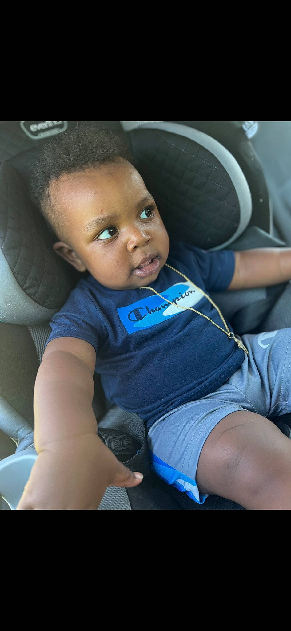 Makhi is registered to the contest to win money with this photo: auto_part, automotive_design, baby, black_hair, car_seat, car_seat_cover, comfort, elbow, electric_blue, flash_photography, head_restraint, knee, leg, person, seat_belt, smile, steering_part, steering_wheel, thigh, toddler