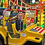 Madison joined the competition — help win amazing prizes! american_flag, amusement_ride, carnival_lights, child, colorful, evening, festival, funfair, glasses, glowing_lights, happy, metal_chain, outdoor, person, seat, smiling, toy_car, vehicle, wheel, yellow_car