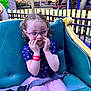 Madison joined the competition — help win amazing prizes! amusement_park, blue_shirt, child, curly_hair, evening, fence, girl, glasses, hands_on_face, outdoor, park, pink_skirt, playful, purple_glasses, ride, seat, seatbelt, smile, sunset, tights