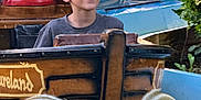 Matthew is registered to the contest to win money with this photo: amusement_park, boy, casual_clothing, child, daylight, fence, fun, greenery, happy, leisure, log_flume, outdoor, portrait, recreation, ride, smiling, superhero_statue, water_ride, water_splash, wooden_boat