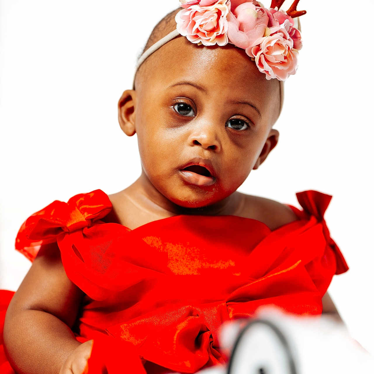 Jaliyah is registered to the contest to win money with this photo: accessories, baby, bodypart, clothing, dress, face, finger, flower, flowerarrangement, flowerbouquet, formalwear, hand, happy, hat, head, headband, person, photography, plant, portrait