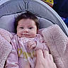 Heavenly is registered to the contest to win money with this photo: baby, infant, child, portrait, smiling, wide_eyed, pink_clothing, polka_dots, blanket, cozy, baby_seat, indoor, home, hand, foot, lying_down, cute, face, soft_lighting, family