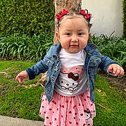 Alaia is registered to the contest to win money with this photo: toddler, child, girl, outdoor, tree, grass, denim_jacket, hello_kitty, pink_skirt, red_hearts, pigtails, hair_bows, sidewalk, smiling, cute, fashion, summer_clothes, person, nature, portrait