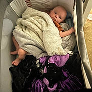 Orion is registered to the contest to win money with this photo: baby, bed, bedroom, blanket, couch, cradle, crib, face, furniture, head, homedecor, indoors, infantbed, linen, person, room