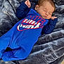 baby, infant, sleeping, blanket, blue_outfit, nike_logo, logo, clothing, face, closed_eyes, hand, fingers, blanket_texture, soft_fabric, cozy, newborn, portrait, skin, hair, resting