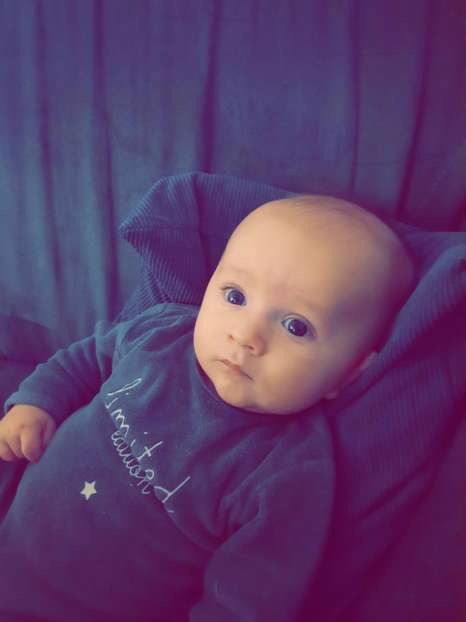 Ezio participe au concours pour gagner de l'argent avec cette photo : baby, baby_toddler_clothing, beanie, cheek, child, comfort, curtain, doll, fur, happy, iris, lip, magenta, nose, person, room, selfie, sitting, sleeve, thumb