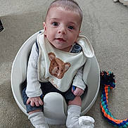 Tristan is registered to the contest to win money with this photo: accessories, baby, bathroom, clothing, costume, face, head, hosiery, indoors, jewelry, necklace, pants, person, photography, portrait, room, sitting, sock, strap, toy