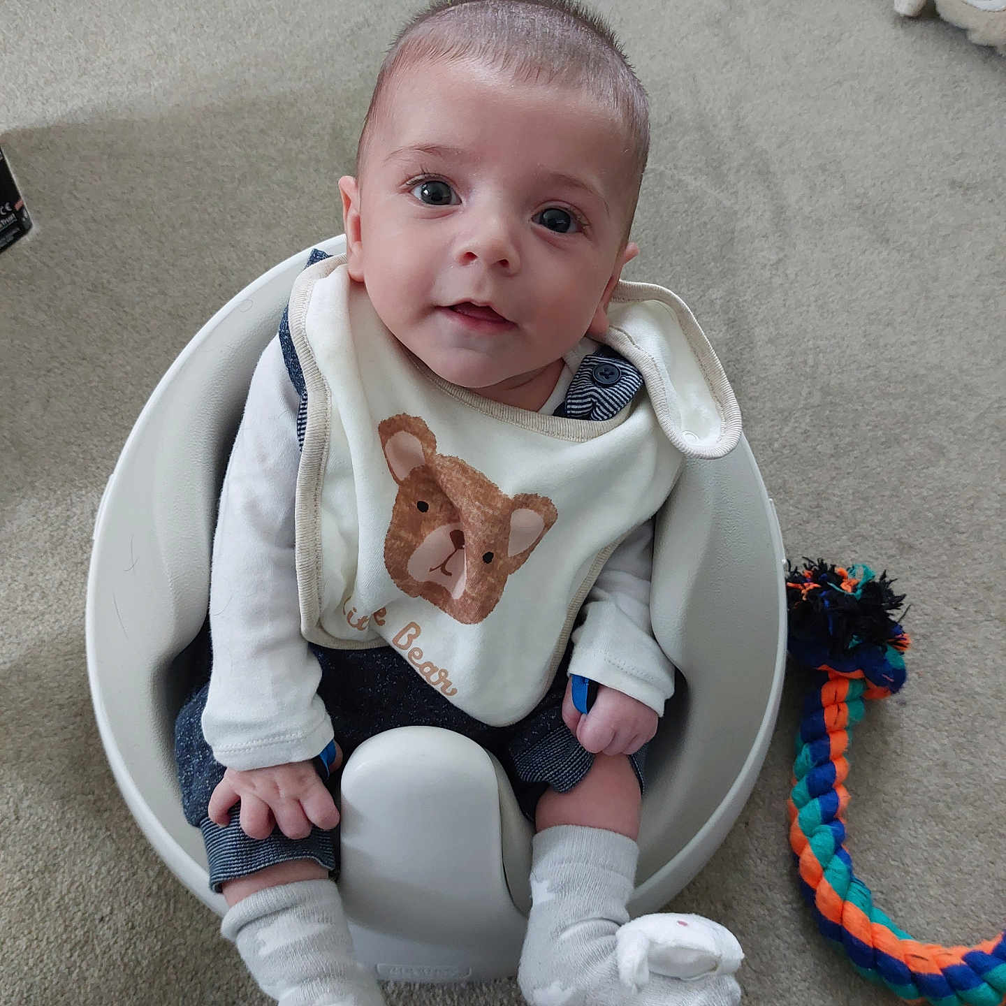 Tristan is registered to the contest to win money with this photo: accessories, baby, bathroom, clothing, costume, face, head, hosiery, indoors, jewelry, necklace, pants, person, photography, portrait, room, sitting, sock, strap, toy