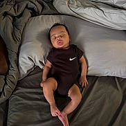 Zaylen joined the competition — help win amazing prizes! baby, sleeping, bed, pillow, blanket, onesie, black_clothing, person, infant, rest, indoor, soft, peaceful, cute, skin, foot, hand, face, young_child, relaxation