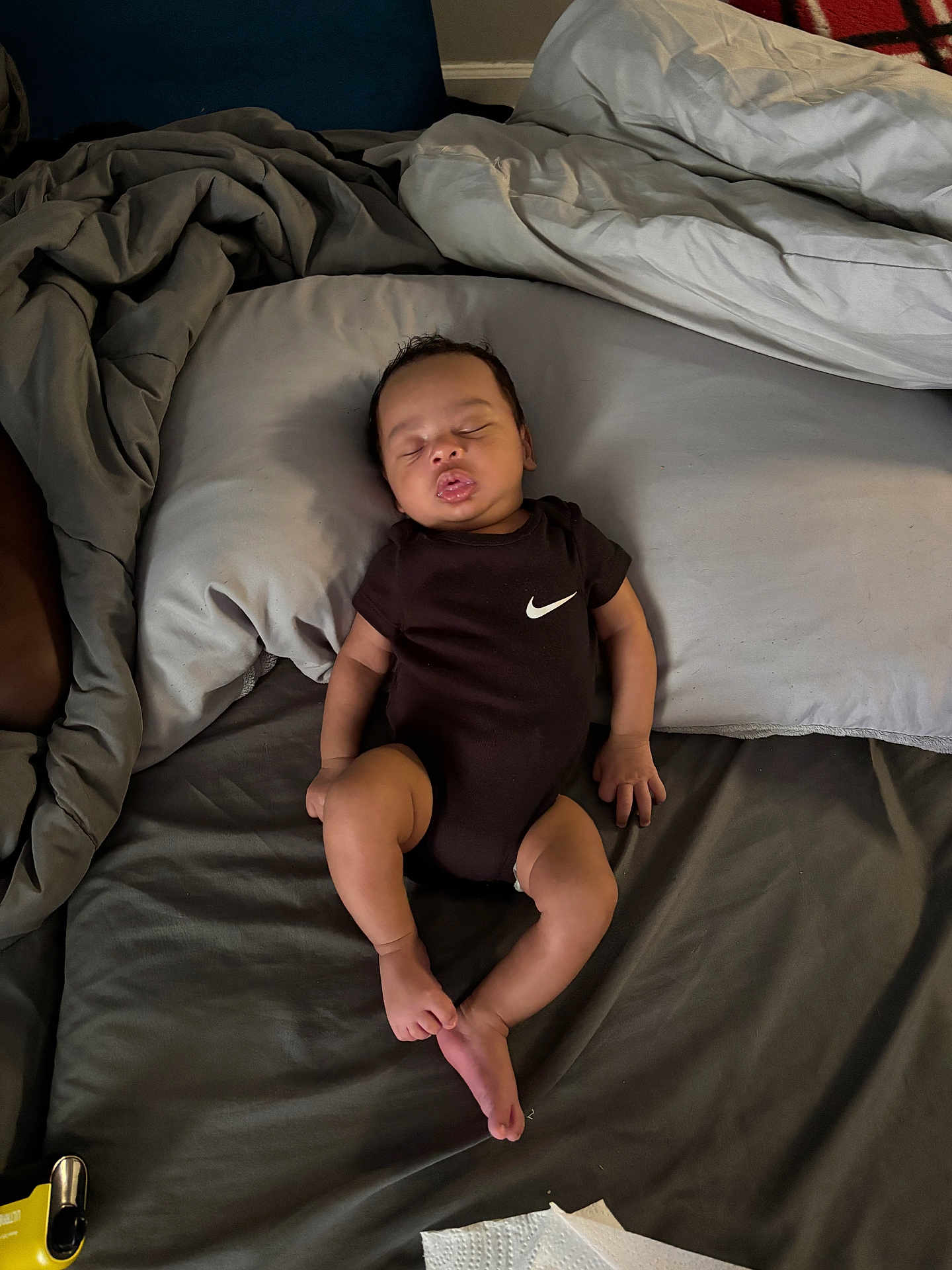 Zaylen joined the competition — help win amazing prizes! baby, sleeping, bed, pillow, blanket, onesie, black_clothing, person, infant, rest, indoor, soft, peaceful, cute, skin, foot, hand, face, young_child, relaxation