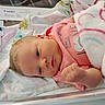 Ashlynn is registered to the contest to win money with this photo: newborn, baby, infant, blanket, pink_clothing, face, sleeping_baby, hospital_bassinet, cute, portrait, skin, hand, eyes, soft, cozy, child, person, resting, fresh, love
