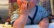 Bentley is registered to the contest to win money with this photo: baby, child, messy, food, spaghetti, high_chair, face, hands, blue_eyes, cute, meal_time, clothing, indoor, expression, person, close_up, feeding, table, plate, funny