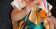 Ariyah joined the competition — help win amazing prizes! baby, child, infant, smiling, happy, portrait, fashion, bow, headband, colorful_clothing, dress, sitting, indoor, couch, textile, close_up, face, eyes, playful, photography