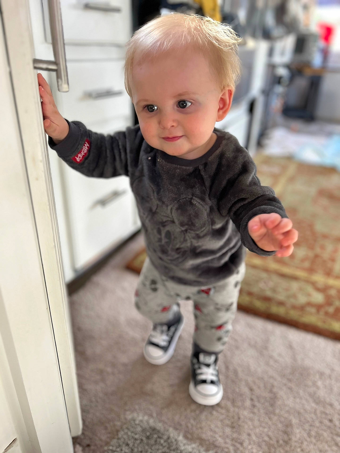 Noah joined the competition — help win amazing prizes! baby, blonde, bodypart, clothing, door, face, finger, footwear, hair, hand, head, jeans, pants, person, photography, portrait, shoe, sitting, sleeve, sneaker