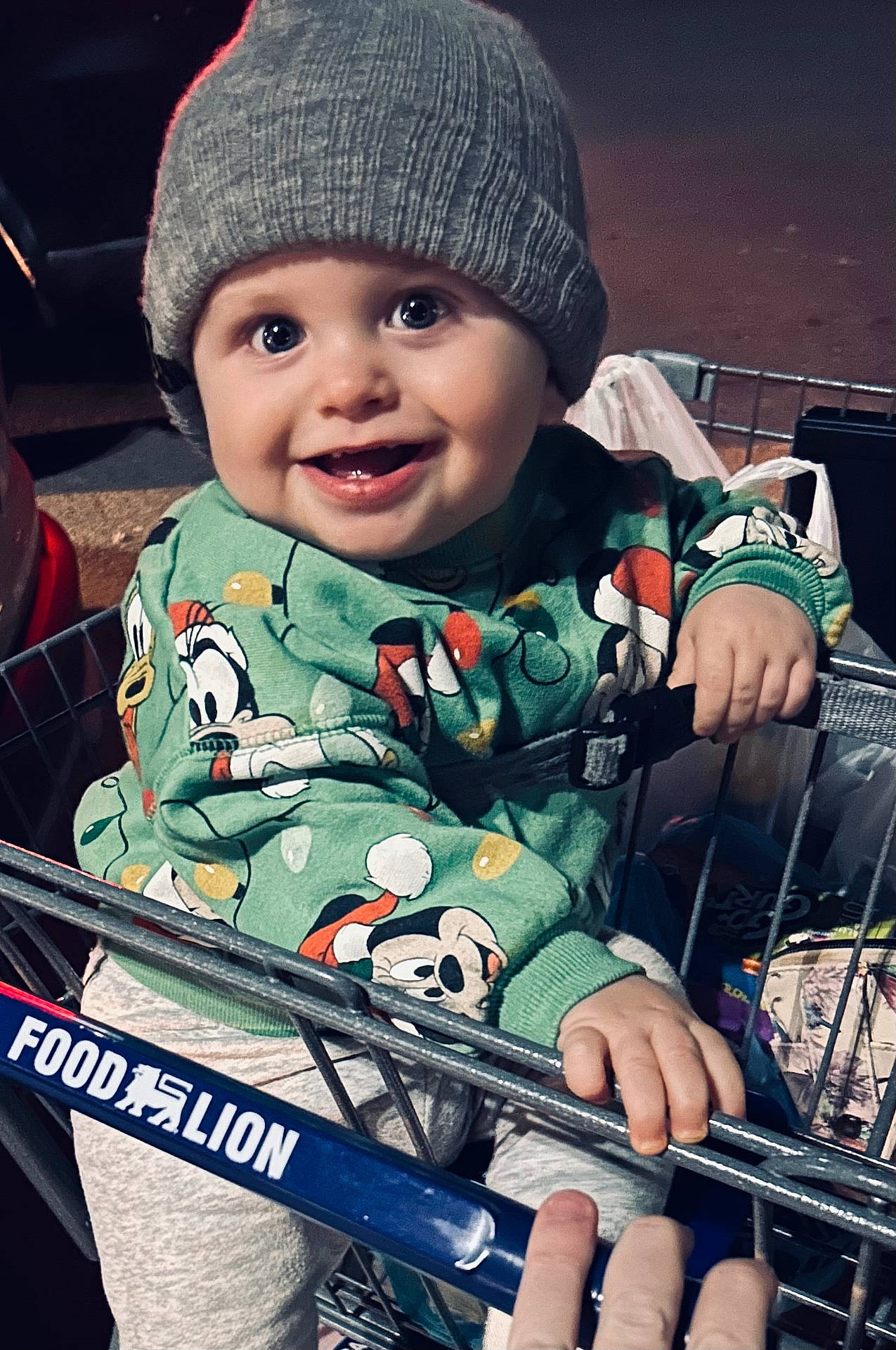 Noah is registered to the contest to win money with this photo: baby, beanie, boy, cap, child, clothing, coat, face, happy, hat, head, jacket, machine, male, person, photography, portrait, shoppingcart, smile, wheel